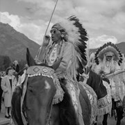 Cover image of Unknown men in regalia on horseback, Banff Indian Days parade